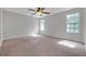 The carpeted bedroom features two windows that provide ample natural light and a ceiling fan at 800 Tradd Ct, Stone Mountain, GA 30087