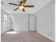 This is a standard bedroom with carpeted floors, a window and two closets at 800 Tradd Ct, Stone Mountain, GA 30087