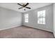 A standard bedroom has carpeted floors, neutral walls and two windows for natural light at 800 Tradd Ct, Stone Mountain, GA 30087