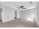 The empty bedroom features carpeted floors, neutral walls, and a lighted ceiling fan at 800 Tradd Ct, Stone Mountain, GA 30087