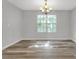 Sun-drenched formal dining room featuring elegant lighting, neutral paint, and stylish flooring at 800 Tradd Ct, Stone Mountain, GA 30087