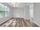 Bright dining room with a chandelier, freshly painted light grey walls, and stylish flooring at 800 Tradd Ct, Stone Mountain, GA 30087