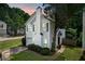 Well-manicured lawn highlights this charming home with blue shuttered windows and an attached garage at 800 Tradd Ct, Stone Mountain, GA 30087