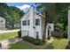 Well-manicured lawn highlights this charming home with blue shuttered windows and an attached garage at 800 Tradd Ct, Stone Mountain, GA 30087