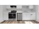 Efficient kitchen featuring stainless steel appliances, light countertops, and bright white cabinetry at 800 Tradd Ct, Stone Mountain, GA 30087