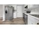 Modern kitchen with stainless steel appliances, white cabinets, and stylish flooring at 800 Tradd Ct, Stone Mountain, GA 30087