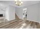 Light-filled living space with modern flooring, stairway and views into the kitchen area at 800 Tradd Ct, Stone Mountain, GA 30087