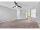 An open living room has neutral walls, carpet and a ceiling fan with light fixture at 800 Tradd Ct, Stone Mountain, GA 30087