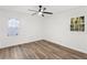 Bright bedroom featuring new wood floors, a ceiling fan, and neutral paint at 1349 Lockhaven Sw Cir, Atlanta, GA 30311