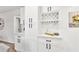 Stylish butler's pantry features white cabinets, quartz countertops, and wine storage at 1349 Lockhaven Sw Cir, Atlanta, GA 30311