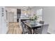 Modern dining area adjacent to a kitchen featuring white cabinets and black accents at 1349 Lockhaven Sw Cir, Atlanta, GA 30311