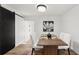 A dining table is set in front of a sliding barn door with rustic finishes at 1349 Lockhaven Sw Cir, Atlanta, GA 30311