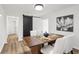 Modern dining room boasts wood floors, barn door, and dining table with seating for four at 1349 Lockhaven Sw Cir, Atlanta, GA 30311