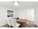 Modern dining room boasts wood floors, an art piece and dining table with seating for four at 1349 Lockhaven Sw Cir, Atlanta, GA 30311