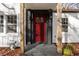 Close-up of a bright red front door with glass panels and natural wood columns at 1349 Lockhaven Sw Cir, Atlanta, GA 30311