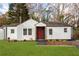 Charming one-story home with white siding, a red front door, and a well-manicured lawn at 1349 Lockhaven Sw Cir, Atlanta, GA 30311