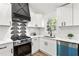 Close up of oven and stovetop area in the kitchen with white and black features at 1349 Lockhaven Sw Cir, Atlanta, GA 30311