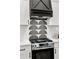 Modern stainless steel oven below a sleek decorative vent hood and backsplash at 1349 Lockhaven Sw Cir, Atlanta, GA 30311