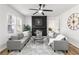 Bright living room with modern fireplace, ceiling fan, and gray sofas at 1349 Lockhaven Sw Cir, Atlanta, GA 30311