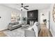 Bright living room with modern fireplace, ceiling fan, and comfortable gray sofas at 1349 Lockhaven Sw Cir, Atlanta, GA 30311