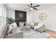 Bright living room with a modern fireplace, ceiling fan, and comfortable gray sofas at 1349 Lockhaven Sw Cir, Atlanta, GA 30311