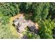 Aerial view showcasing the home's placement on a large, private lot surrounded by trees at 220 Mars Hill Rd, Powder Springs, GA 30127