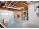 Unfinished basement with an open garage door and exposed beams at 220 Mars Hill Rd, Powder Springs, GA 30127