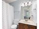 Cozy bathroom with a shower curtain, vanity, and a well-lit mirror at 220 Mars Hill Rd, Powder Springs, GA 30127