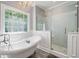 Bright bathroom with freestanding tub, glass enclosed shower, large window, and elegant chandelier at 220 Mars Hill Rd, Powder Springs, GA 30127
