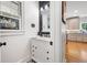 Charming half bath with a marble countertop, black hardware, and decorative mirror at 220 Mars Hill Rd, Powder Springs, GA 30127