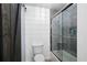 Modern bathroom featuring shiplap walls, a glass-enclosed shower, and a dark barn door at 220 Mars Hill Rd, Powder Springs, GA 30127