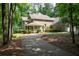 Beautiful home featuring a manicured lawn, mature trees, and a welcoming front porch at 220 Mars Hill Rd, Powder Springs, GA 30127