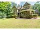 Charming two-story home with lush lawn and inviting wraparound porch, perfect for enjoying peaceful outdoor living at 220 Mars Hill Rd, Powder Springs, GA 30127