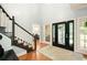 Elegant home foyer featuring a grand staircase and gleaming hardwood floors, creating a welcoming atmosphere at 220 Mars Hill Rd, Powder Springs, GA 30127