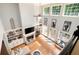 Sun-filled living room with built-in shelving, fireplace, piano, and multiple doors to the outside at 220 Mars Hill Rd, Powder Springs, GA 30127