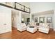 Open-concept living room with hardwood floors, a cozy seating area, and plenty of natural light at 220 Mars Hill Rd, Powder Springs, GA 30127