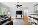 Comfortable living room with hardwood floors, ceiling fan, and access to a bar area at 220 Mars Hill Rd, Powder Springs, GA 30127