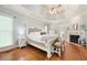 Serene main bedroom with hardwood floors, tray ceilings, and a cozy fireplace at 220 Mars Hill Rd, Powder Springs, GA 30127