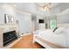 Spacious main bedroom boasts hardwood floors, tray ceilings, fireplace, and a ceiling fan at 220 Mars Hill Rd, Powder Springs, GA 30127