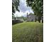 Expansive backyard featuring a well-maintained lawn and mature trees at 5030 N Bridges Dr, Alpharetta, GA 30022