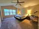 Bright bedroom featuring carpet, ceiling fan, large window, and decor at 5030 N Bridges Dr, Alpharetta, GA 30022