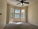 Bright bedroom featuring a ceiling fan and multiple windows at 5030 N Bridges Dr, Alpharetta, GA 30022