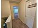 Hallway leading to a brightly lit room with a ceiling fan and multiple windows at 5030 N Bridges Dr, Alpharetta, GA 30022
