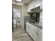 Well-lit kitchen with white cabinets and stainless steel dishwasher at 5030 N Bridges Dr, Alpharetta, GA 30022