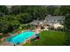Beautiful backyard with a pool, ample seating, and a well-maintained lawn with mature trees at 555 Valley Hall Dr, Atlanta, GA 30350