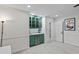 A convenient bar area with green cabinetry, a sink, beverage cooler, and decorative accents at 555 Valley Hall Dr, Atlanta, GA 30350