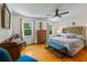 Bright bedroom with hardwood floors, windows, tufted headboard, and bench at 555 Valley Hall Dr, Atlanta, GA 30350