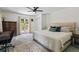 Spacious bedroom with a large bed, desk, and access to the backyard through French doors at 555 Valley Hall Dr, Atlanta, GA 30350