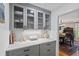 Convenient butlers pantry featuring ample cabinet storage, marble countertops, and easy access to the dining area at 555 Valley Hall Dr, Atlanta, GA 30350
