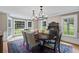 Bright dining room featuring large windows, hardwood floors, an ornate chandelier, and elegant furnishings at 555 Valley Hall Dr, Atlanta, GA 30350